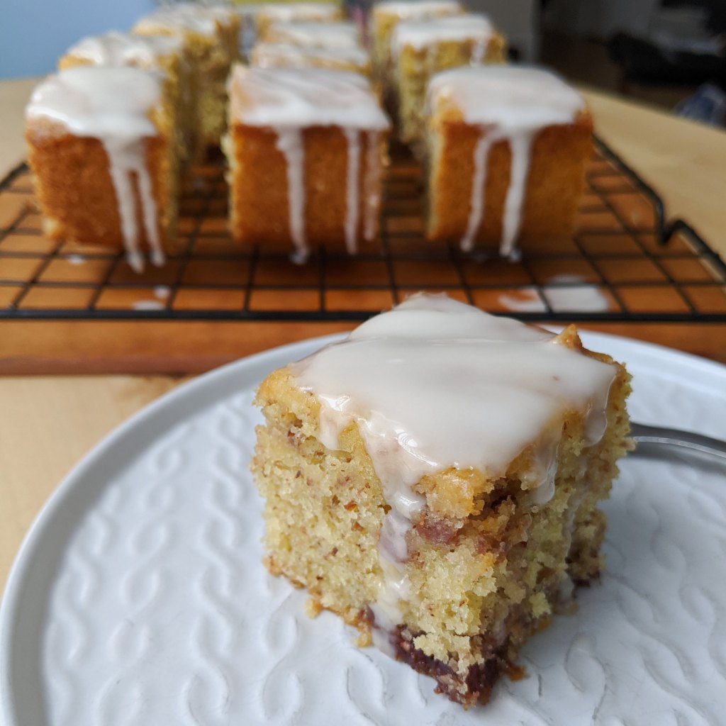 A slice of lemon raspberry cake with icing over top